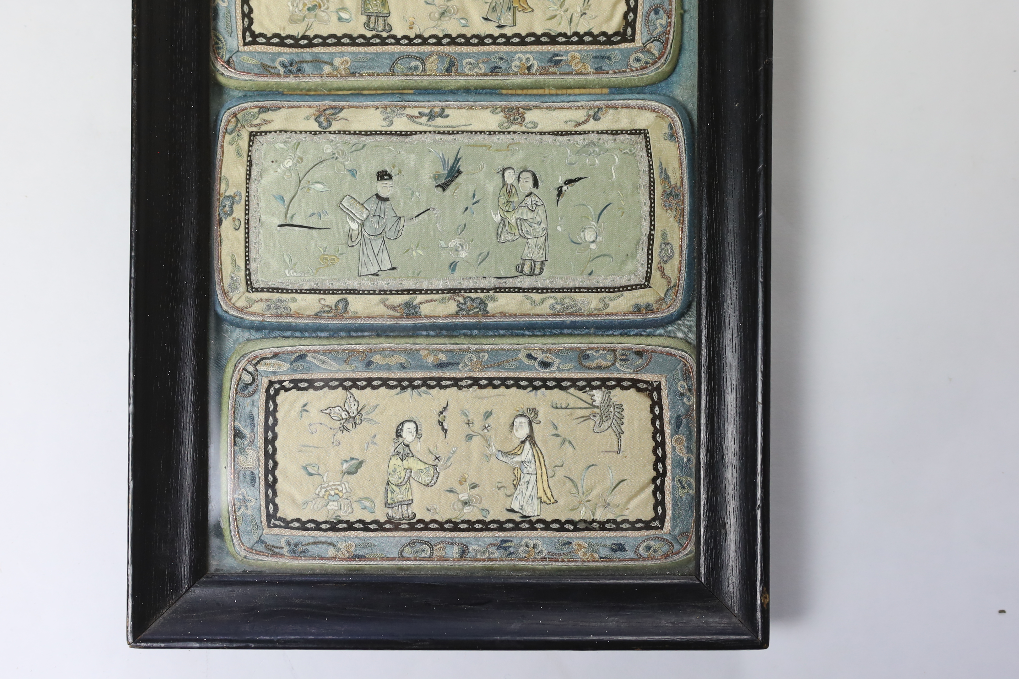 Two pairs of Chinese silk figurative embroidered panels (framed together), being the front and back panels of two spectacle cases, embroidered with very fine embroidery, using Chinese knot in the borders, 15.5cm wide x 3